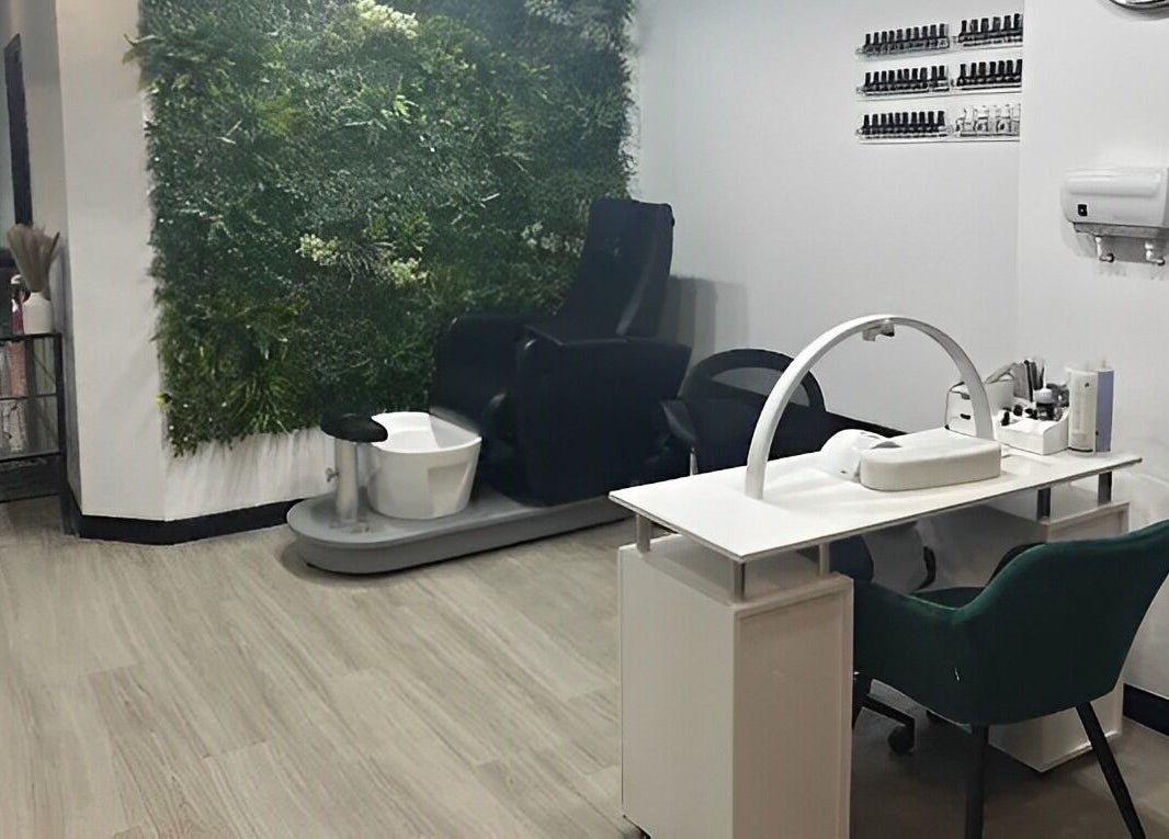 Relaxing nail station at Hair and Beauty Hub, Kettering, England, GB with a green plant wall feature.