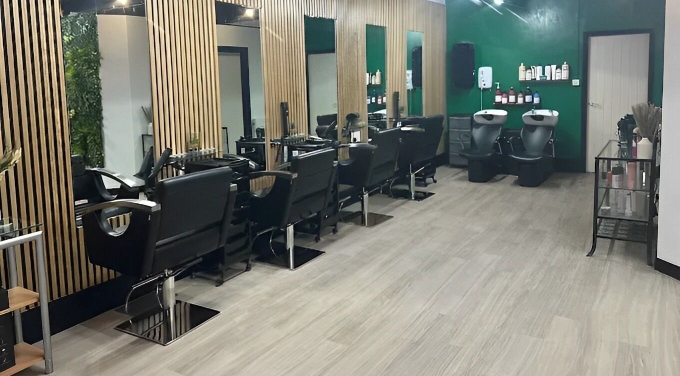 Modern salon at Hair and Beauty Hub, Kettering, England, GB with sleek chairs and wooden accents.