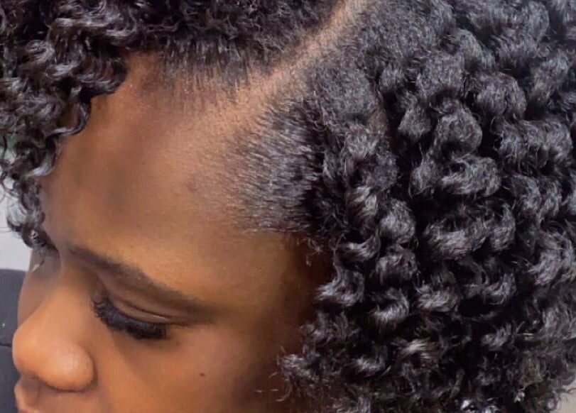 Close-up of curls styled at Melanin n’ Coils, Grand Bahama, BS, showcasing intricate natural hair design.
