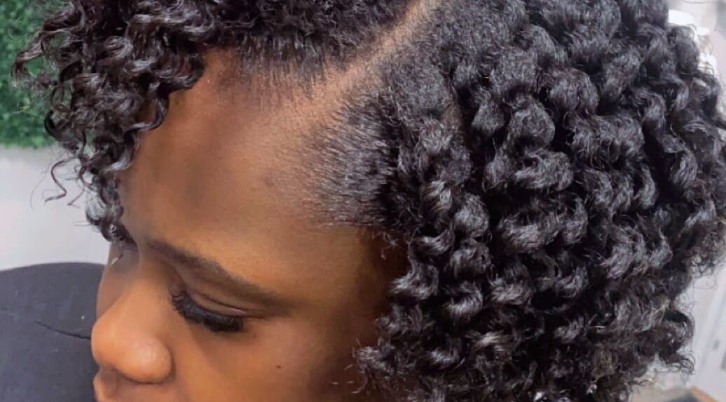 Close-up of curls styled at Melanin n’ Coils, Grand Bahama, BS, showcasing intricate natural hair design.