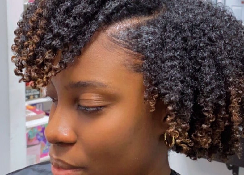 Stylish curly hairstyle at Melanin n’ Coils, Grand Bahama, BS. Perfect blend of texture and flair.