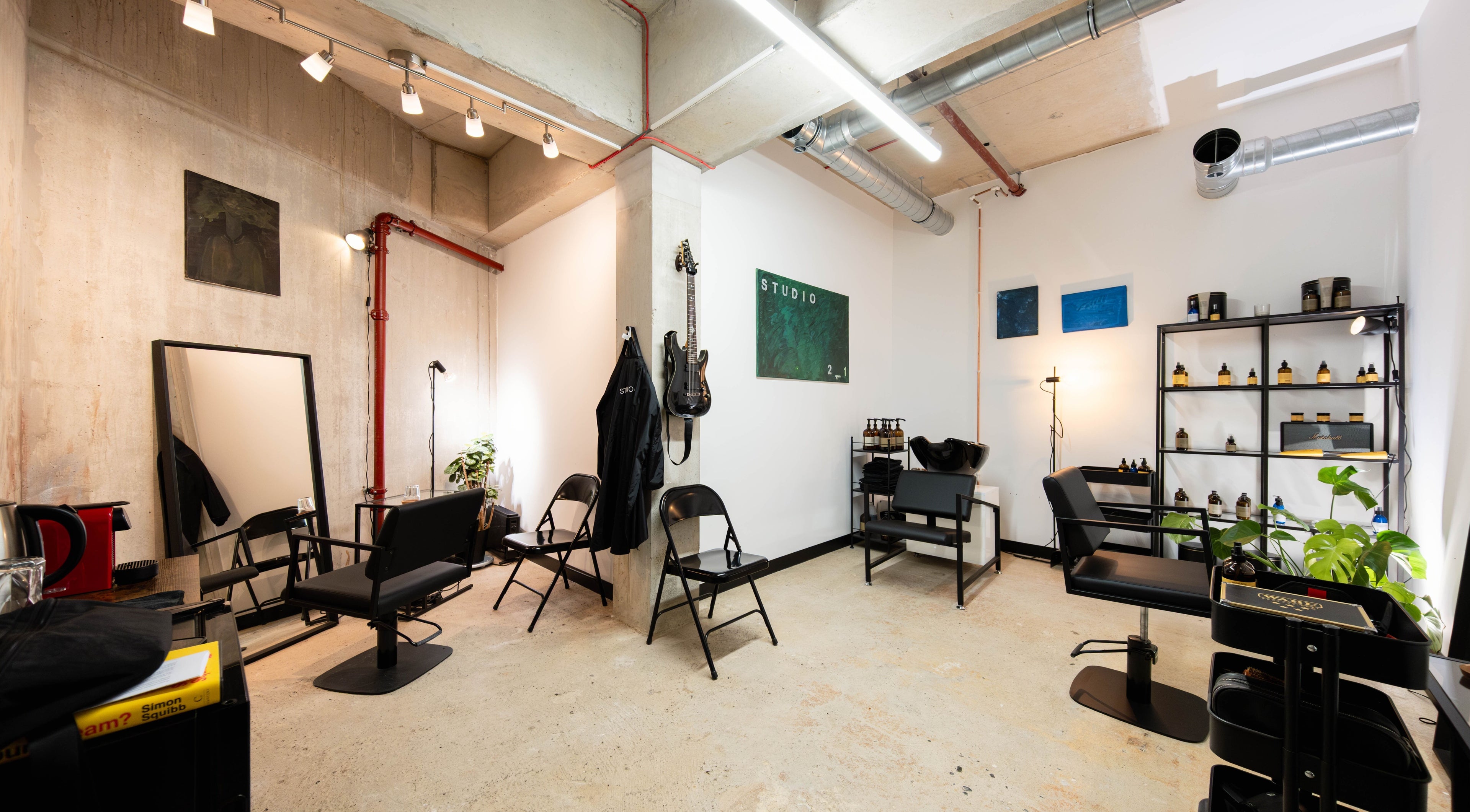 Chic interior of Studio 211 - Hair in London, England, GB, featuring modern salon chairs and sleek decor.