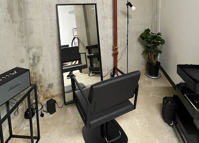 Modern styling chair and mirror at Studio 211 - Hair, London, England, GB. Industrial and sleek design.