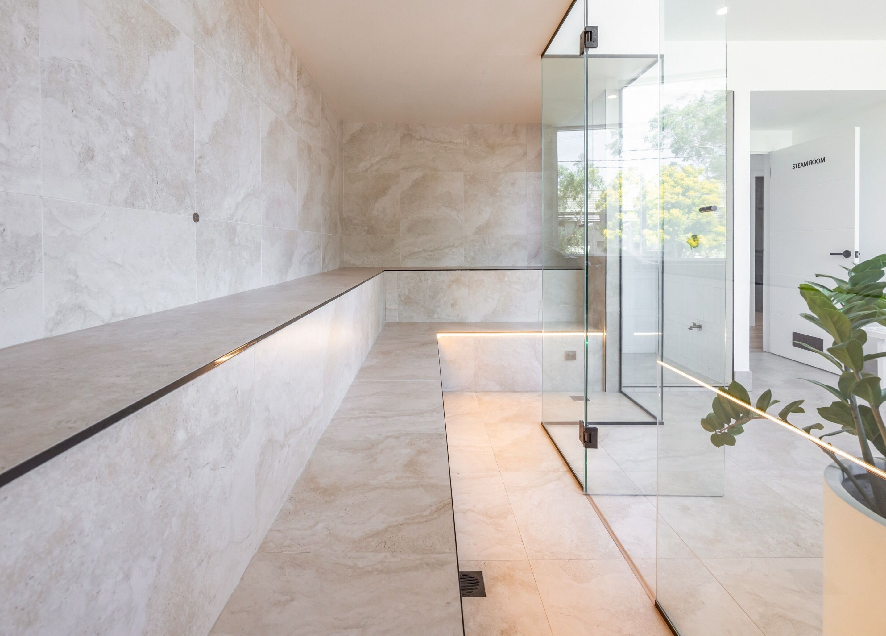 Modern steam room at Sweat Chill Exhale, Caringbah, New South Wales, AU with sleek glass and marble design.