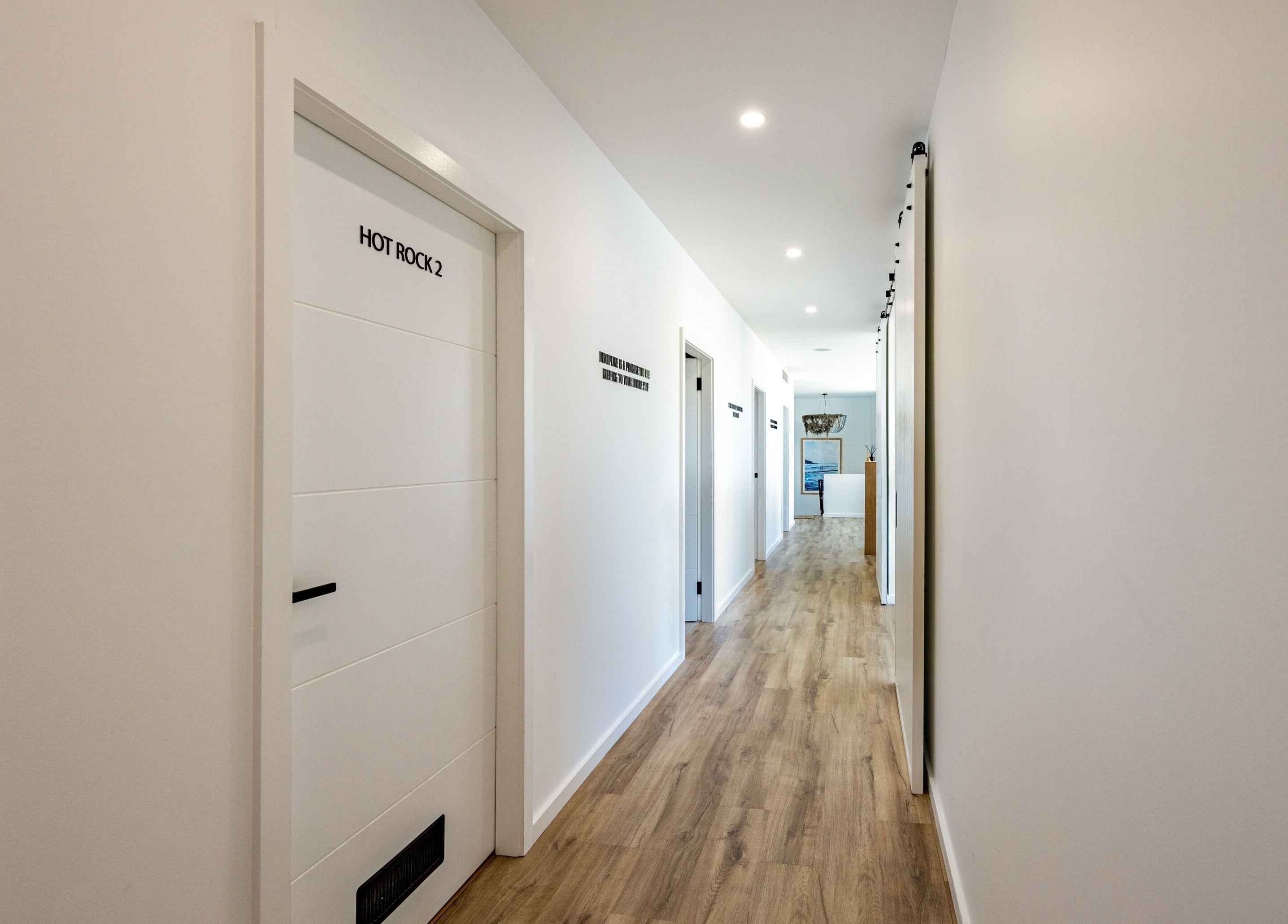 Hallway in Sweat Chill Exhale, Caringbah, New South Wales, AU, featuring modern doors and calming lighting.