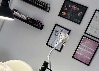 Wall of certifications at Nails By Jess, St Austell, England, showcasing professional nail artistry and excellence.