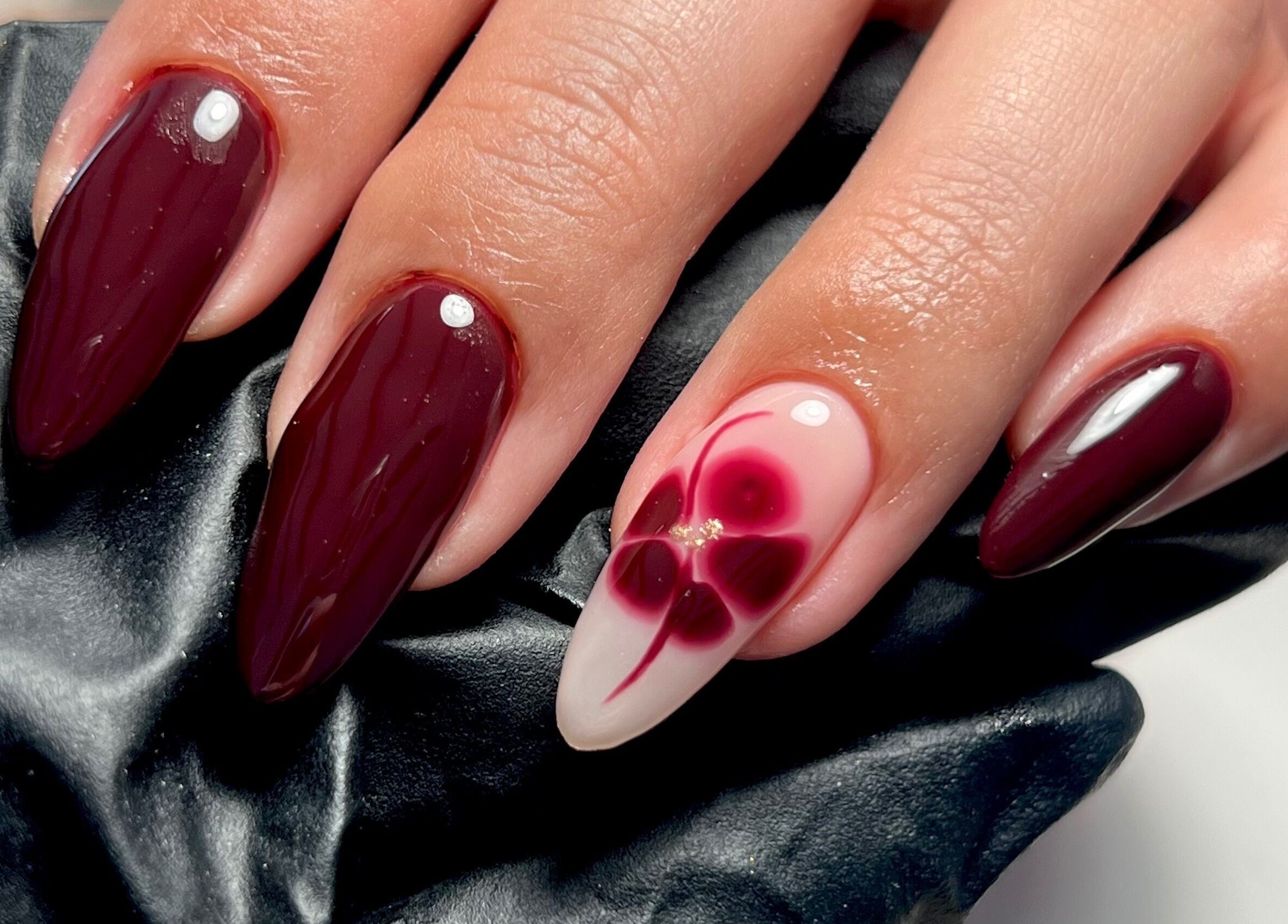 Elegant maroon and floral nail art at Nails By Jess in St Austell, England, GB.