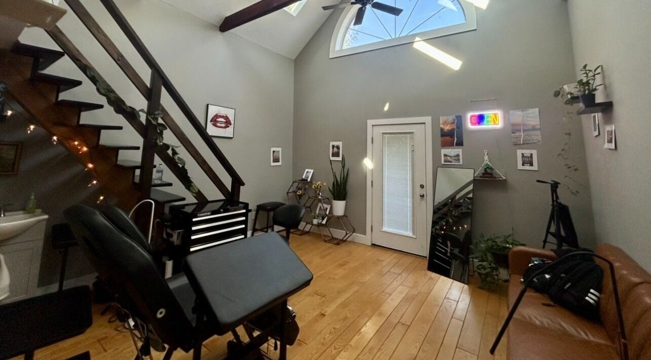 Interior of Black Canvas Tattoos, a stylish loft in Elkhart, Indiana, US, with modern decor and tattoo station.