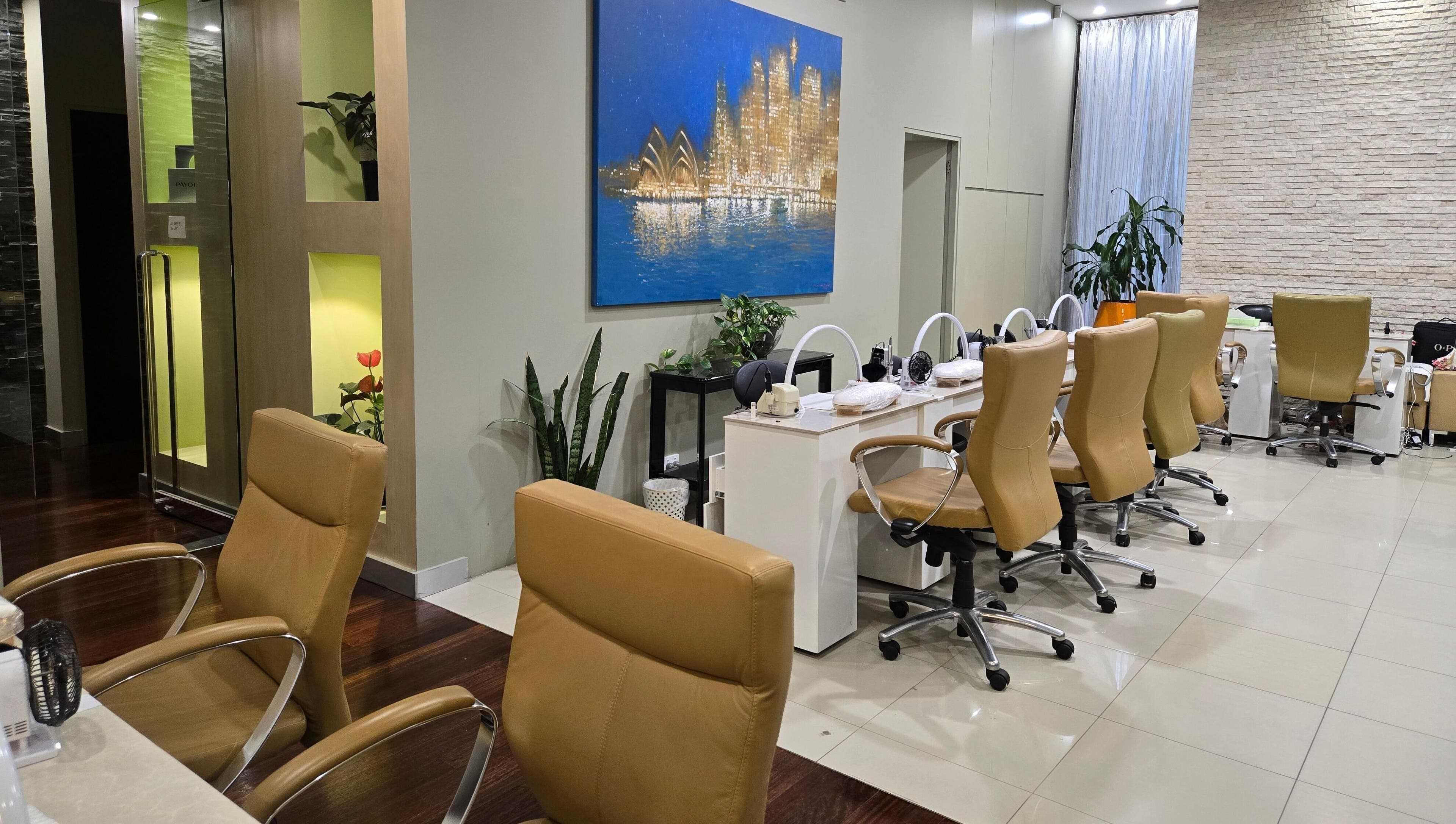 Chic interior of Glow District Beauty, Sydney, NSW, showcasing modern salon chairs and decor.