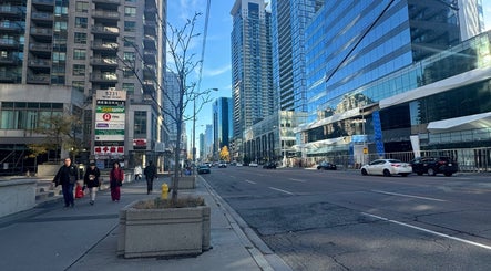 Street view near LV Aestheticca in Toronto, Ontario, CA, showcasing modern skyscrapers and bustling city life.