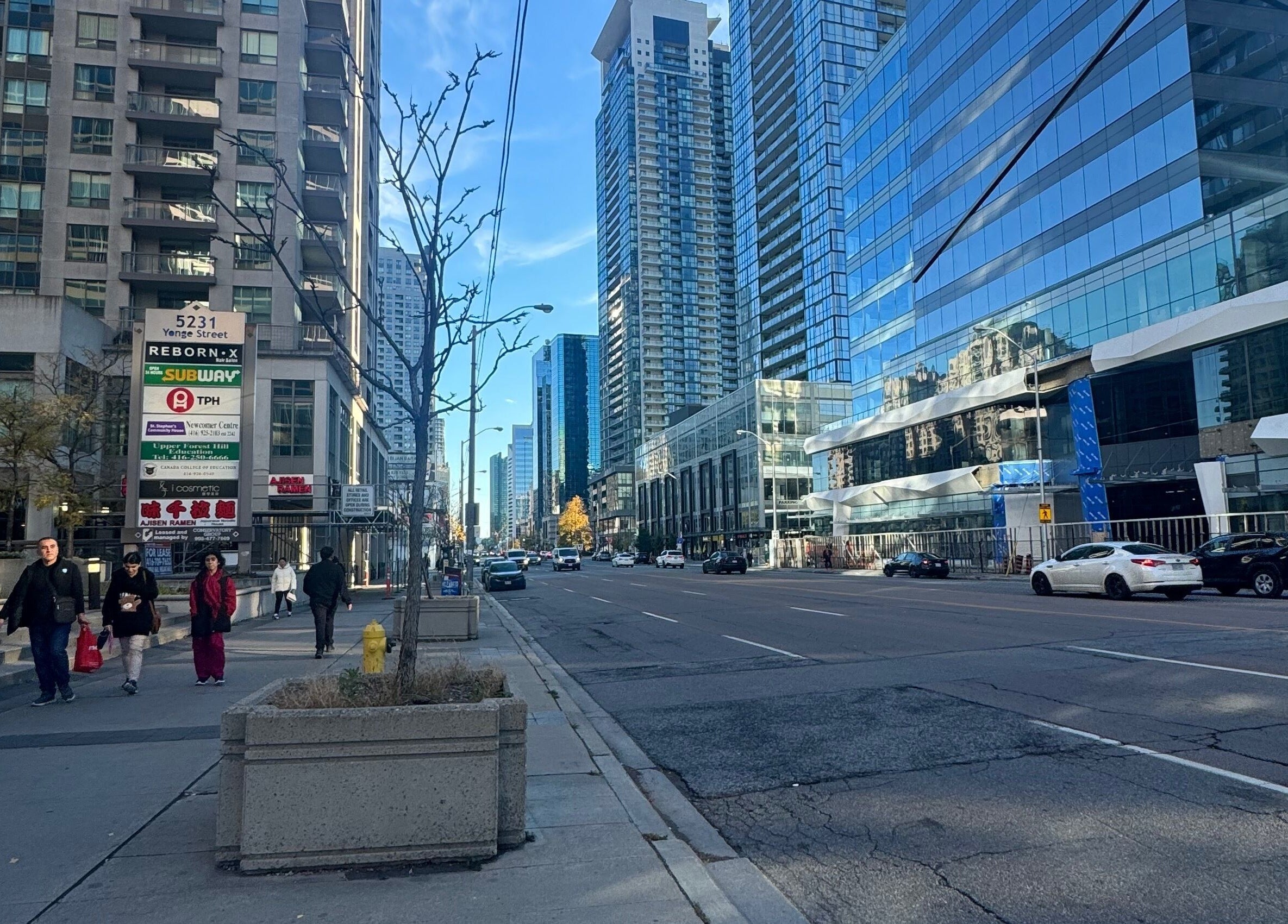 Street view near LV Aestheticca in Toronto, Ontario, CA, featuring modern high-rise buildings.