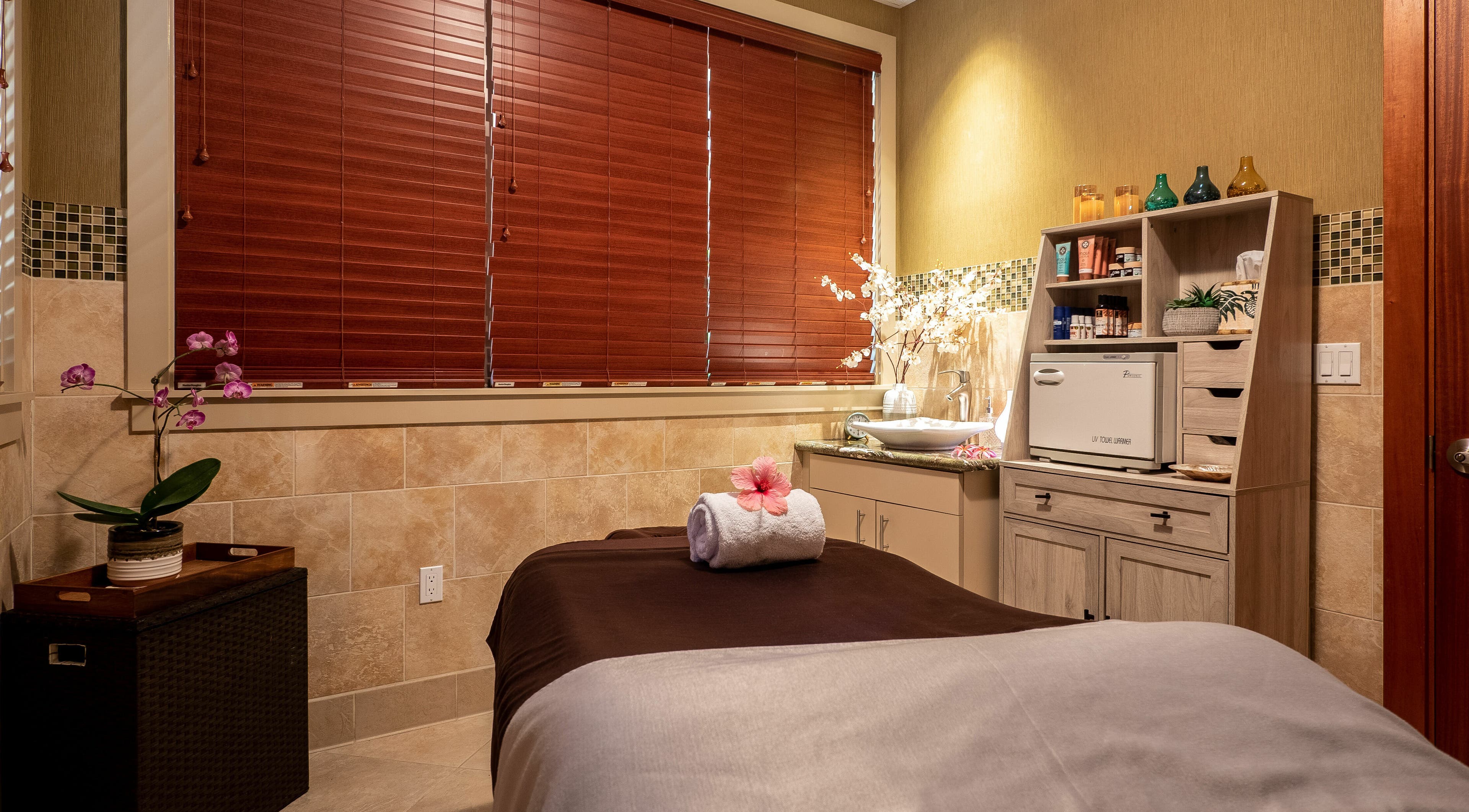 Relaxing massage room at Kaanapali Alii Wellness, Lahaina, Hawaii, US, featuring elegant decor and soft lighting.