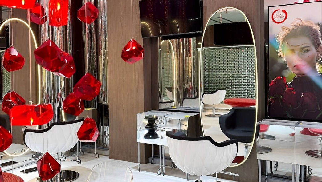 Elegant interior of Aldo Coppola Salon in Dubai, Dubai, AE, showcasing bold red accents and mirrored decor.