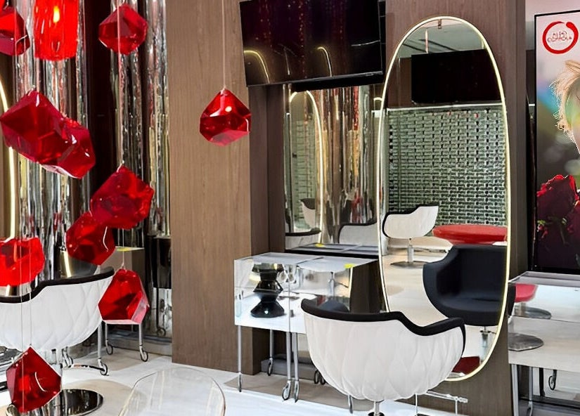 Elegant interior of Aldo Coppola Salon in Dubai, Dubai, AE, showcasing bold red accents and mirrored decor.