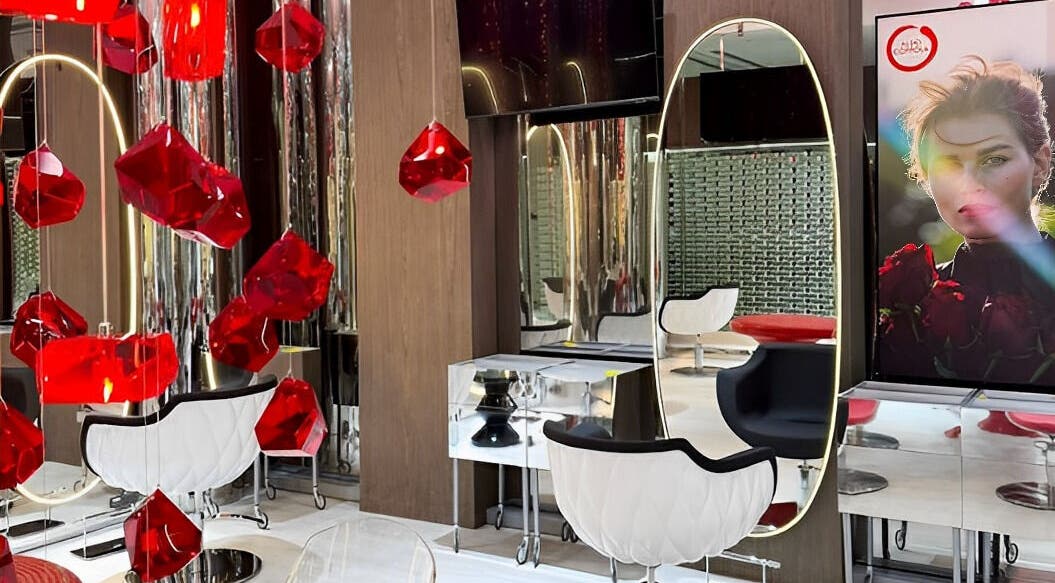 Elegant interior of Aldo Coppola Salon in Dubai, Dubai, AE, showcasing bold red accents and mirrored decor.
