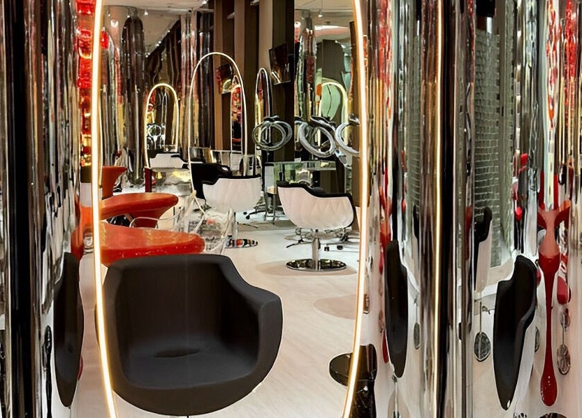 Chic interior of Aldo Coppola Salon in Dubai, Dubai, AE showcasing sleek, modern salon chairs and decor.