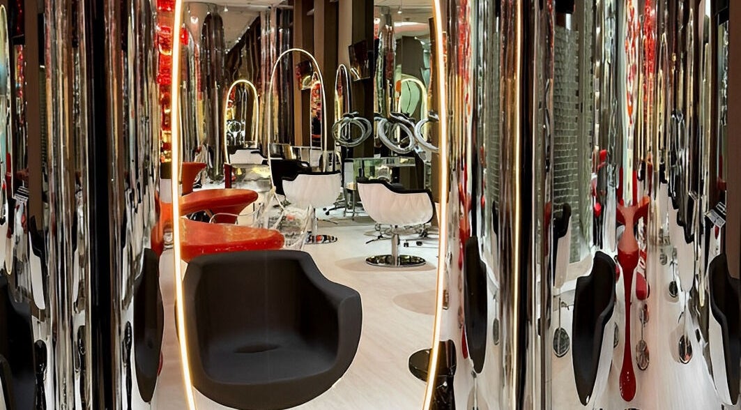Chic interior of Aldo Coppola Salon in Dubai, Dubai, AE showcasing sleek, modern salon chairs and decor.