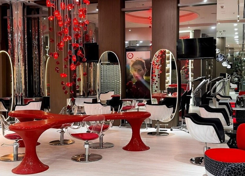 Stylish interior of Aldo Coppola Salon, Dubai, Dubai, AE with modern red and black decor.
