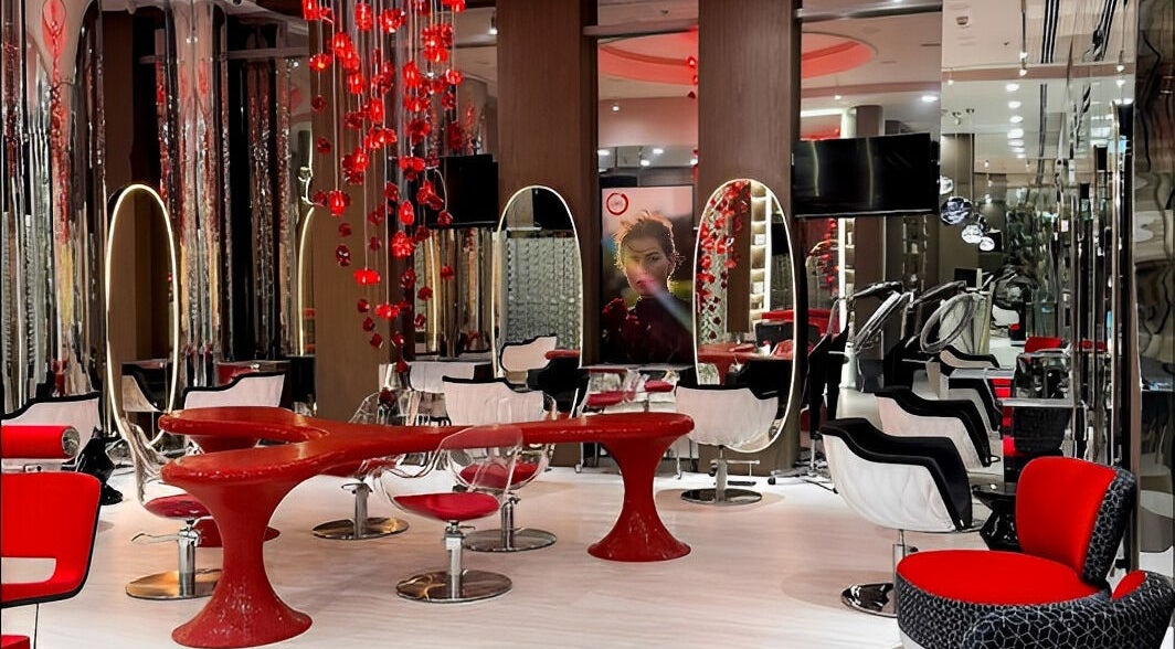 Stylish interior of Aldo Coppola Salon, Dubai, Dubai, AE with modern red and black decor.