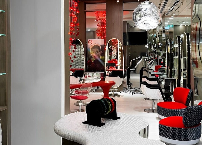 Modern interior of Aldo Coppola Salon in Dubai, Dubai, AE, featuring stylish red and black decor.