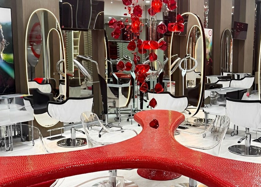 Luxurious interior of Aldo Coppola Salon, Dubai, Dubai, AE with red accents and stylish seating.