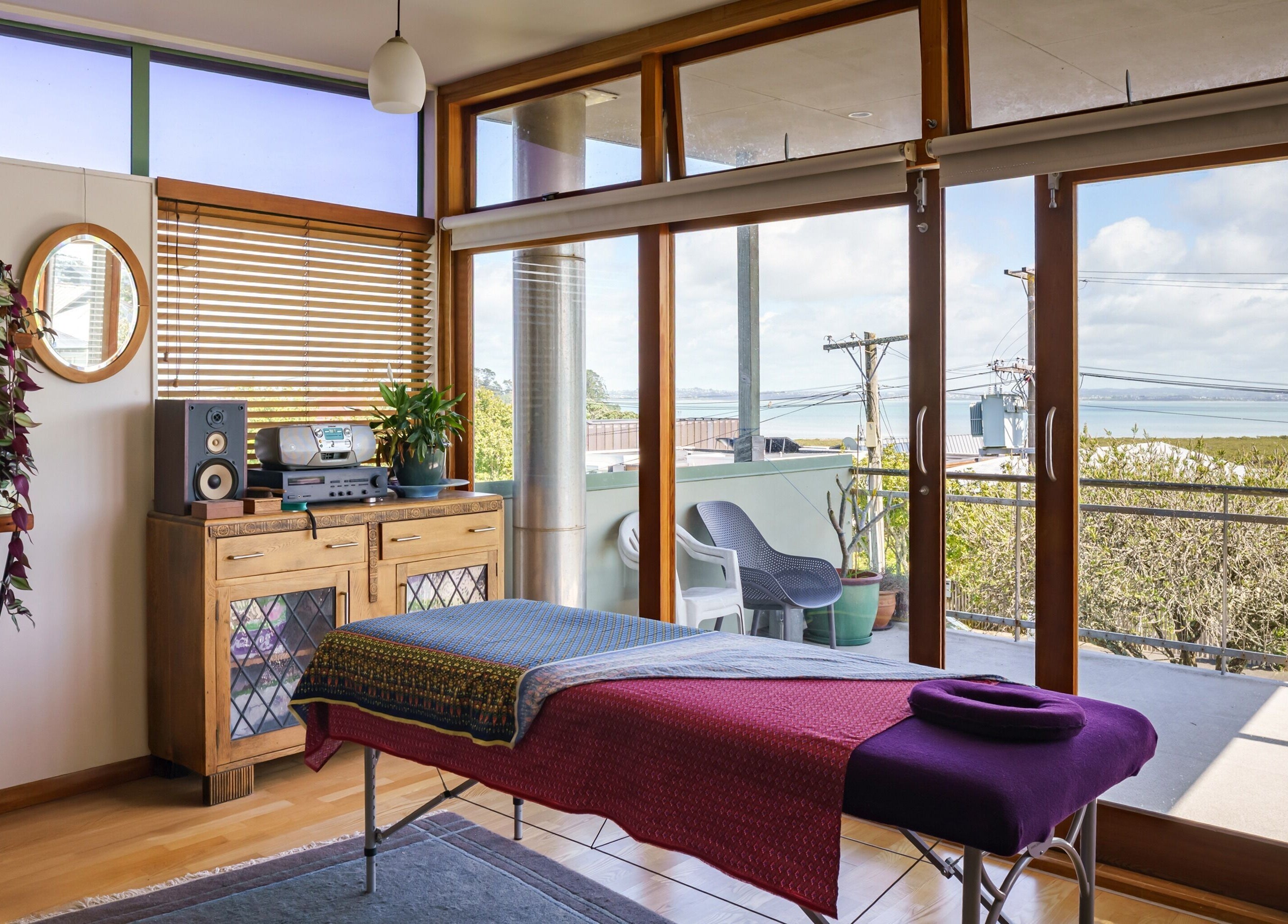 Tranquil massage space at Mob Mass- Mobile Massage Therapy in Auckland, NZ with a scenic view.