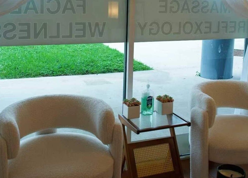 Cozy seating area at Eden Spa Massage and Facial, Pembroke Pines, Florida, US with greenery view.