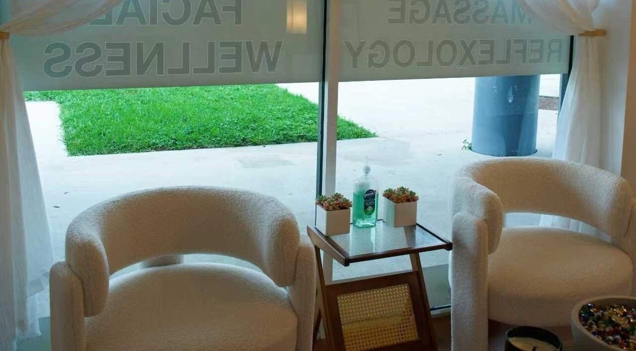 Cozy seating area at Eden Spa Massage and Facial, Pembroke Pines, Florida, US with greenery view.