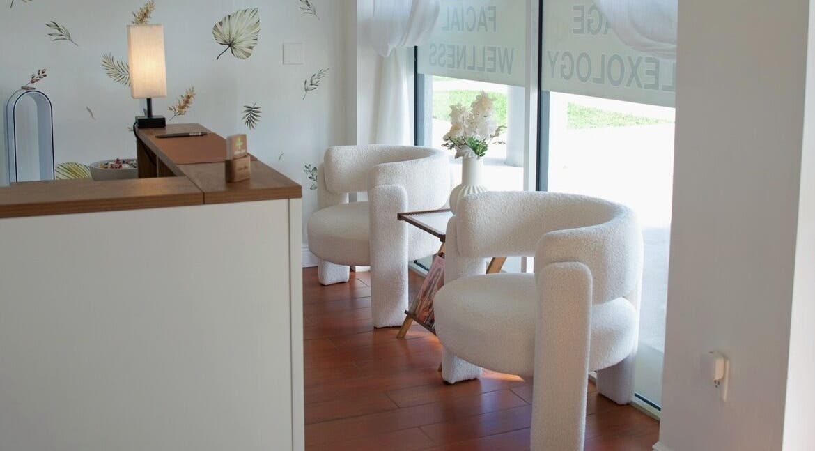 Chic lounge area at Eden Spa Massage and Facial in Pembroke Pines, Florida, US, with cozy white chairs.