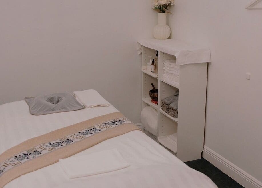 Serene massage room at Eden Spa Massage and Facial, Pembroke Pines, Florida, US, with a tidy bed and calming decor.