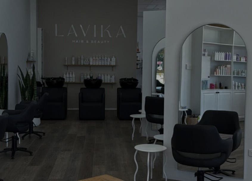 Spacious salon interior at Hair By Jenna Lutgens, Melbourne, Victoria, AU, featuring modern styling chairs and mirrors.