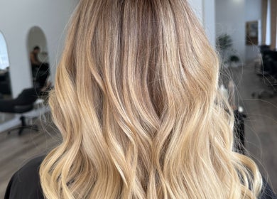 Elegant blonde waves styled at Hair By Jenna Lutgens in Melbourne, Victoria, AU featuring soft, flowing curls.