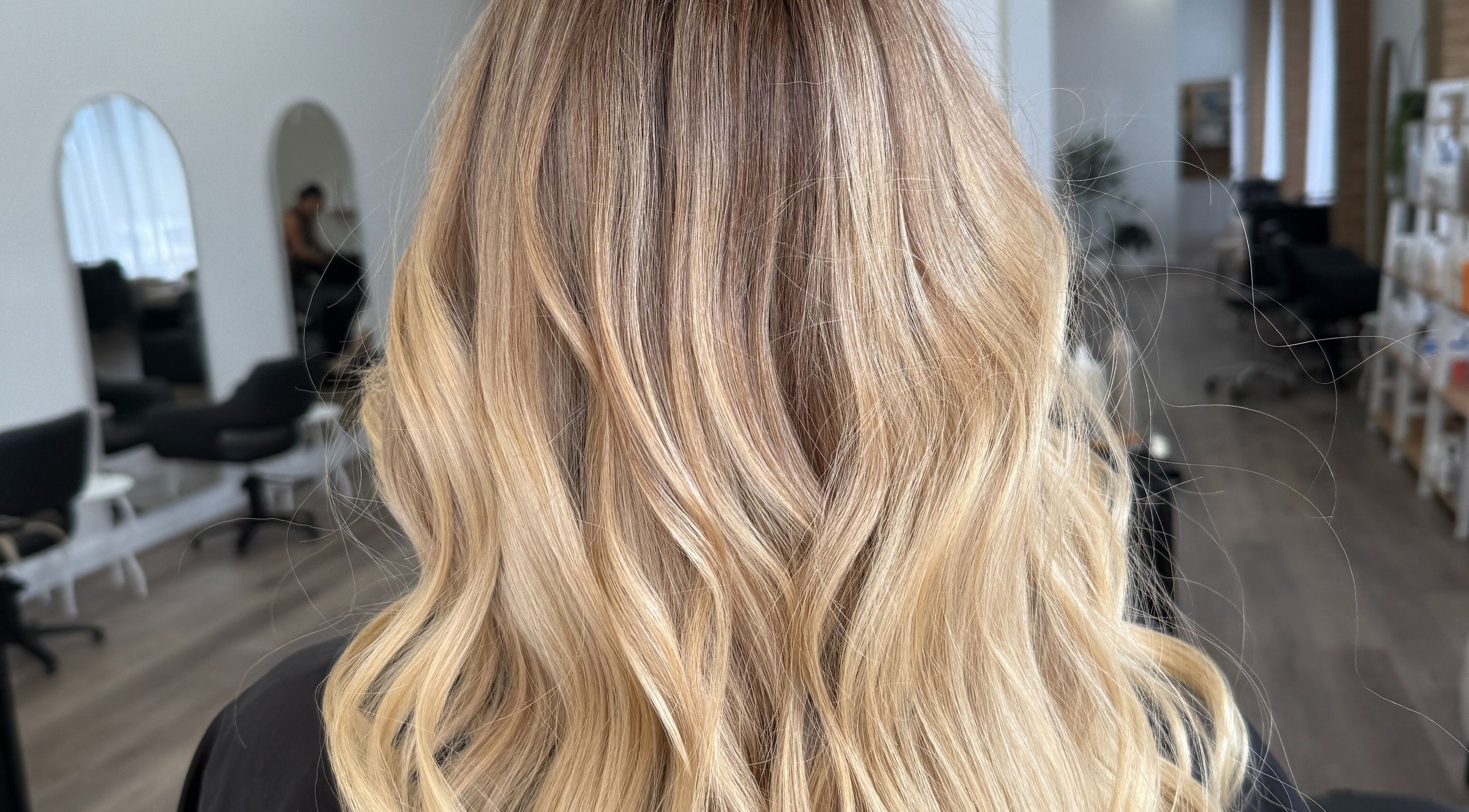 Elegant blonde waves styled at Hair By Jenna Lutgens in Melbourne, Victoria, AU featuring soft, flowing curls.