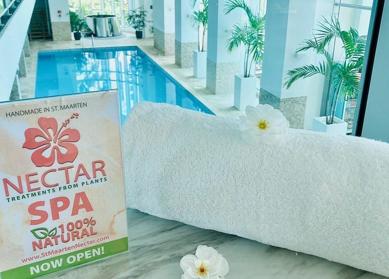Plush towel and serene pool at Nectar Spa at the Cliff, Sint Maarten, SX, offering pure relaxation.
