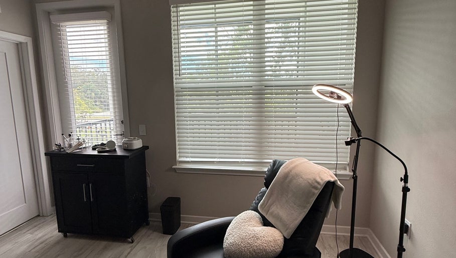 Relaxing treatment room at XBrows with reclining chair and soft lighting, located in Orlando, Florida, US.