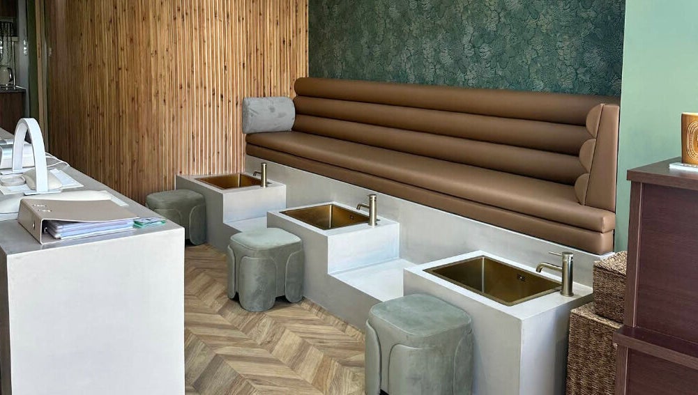 Stylish pedicure area at SOAK, London, England, GB, featuring plush seating and modern decor.