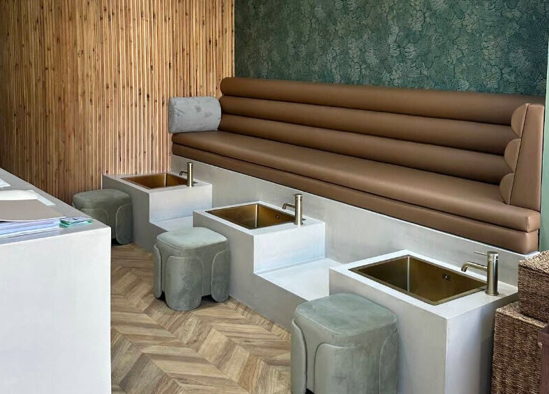 Stylish pedicure area at SOAK, London, England, GB, featuring plush seating and modern decor.
