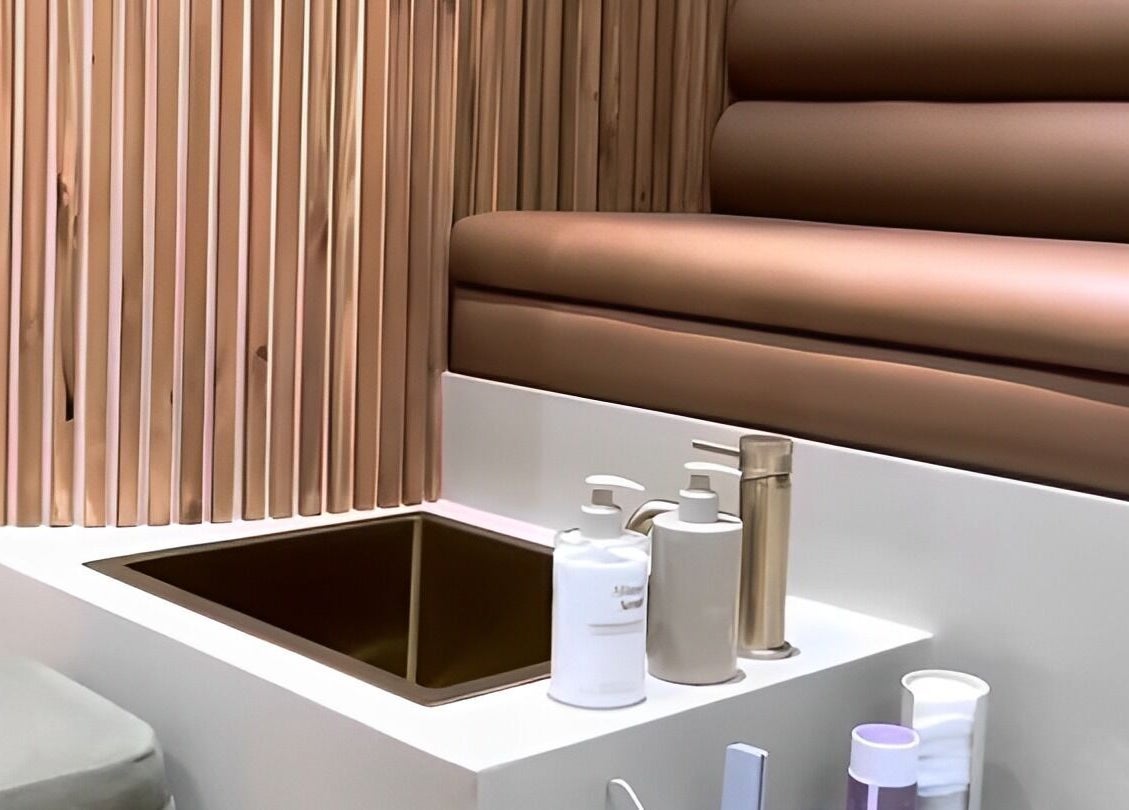 Luxurious spa interior at SOAK, London, England, GB featuring elegant sink and plush seating.