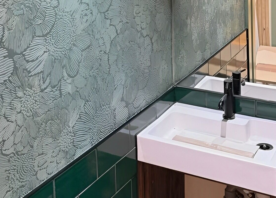 Stylish bathroom at SOAK in London, England, GB featuring elegant floral wallpaper and modern sink.