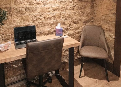 Elegant therapy room at The Pumphouse- Glendon Lodge Farm Kettering, England, GB, featuring a wooden desk and chairs.