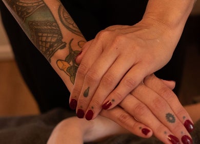 Close-up of tattooed hands providing a massage at Black Market - Leicester, Leicester, England, GB.