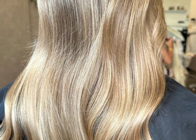 Blonde hair styled beautifully at Angel Locks, Bournemouth, England, GB. Shiny waves reflect salon expertise.