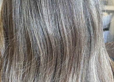 Close-up of silky, ash-blonde hair styled at Angel Locks, Bournemouth, England, GB.