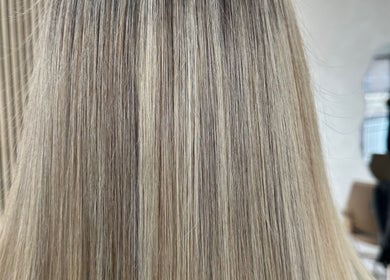 Blonde hair with highlights styled at Angel Locks, Bournemouth, England, GB in a modern salon setting.