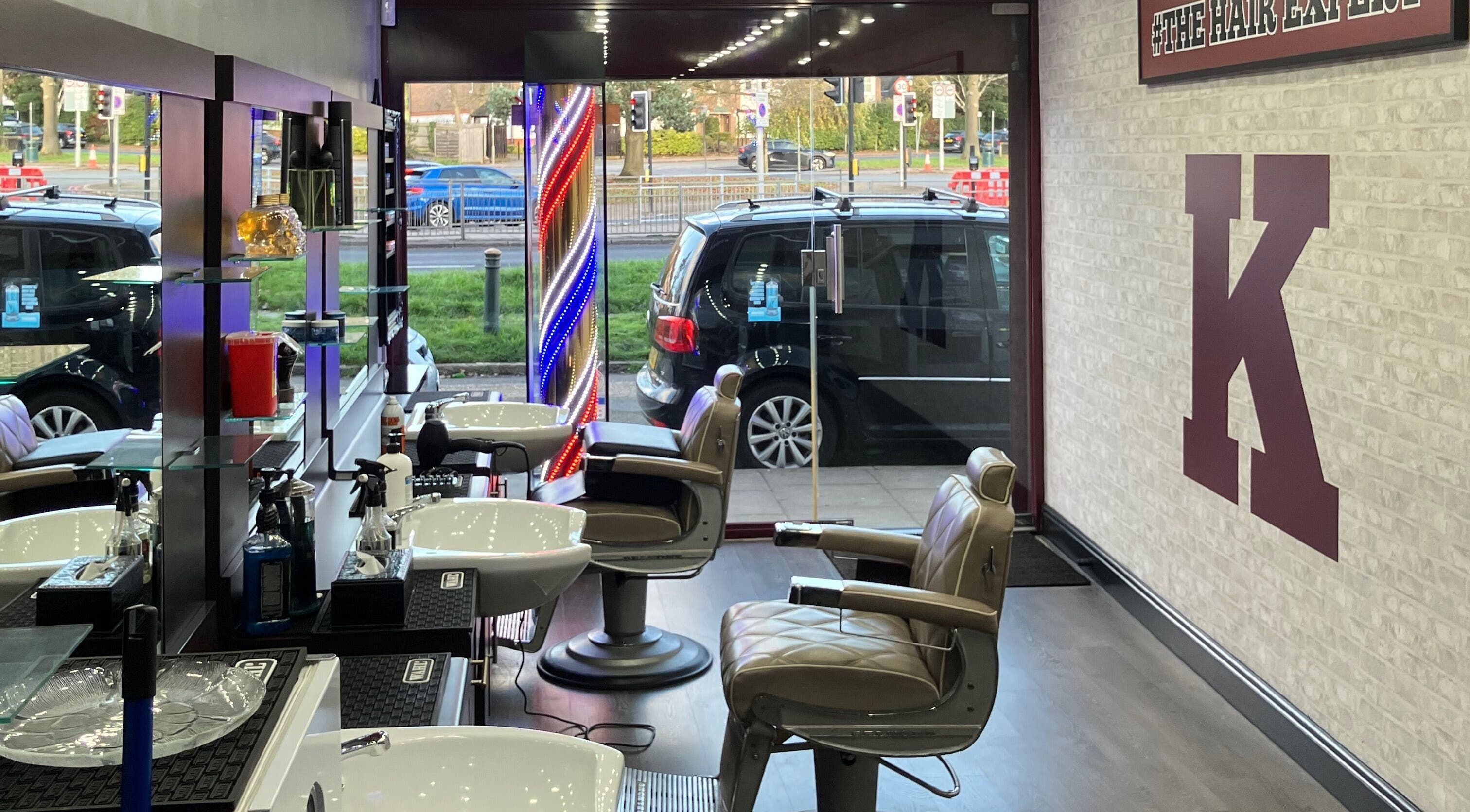 Stylish interior of K The Hair Expert, London, England. Organized styling chairs and vibrant decor.