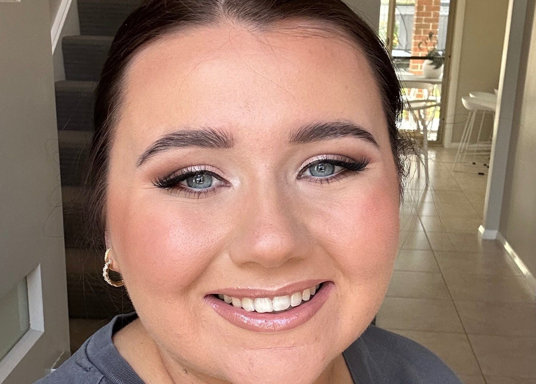 Smiling woman with flawless makeup at Lux Aesthetics By Sophie, Narellan, New South Wales, AU.