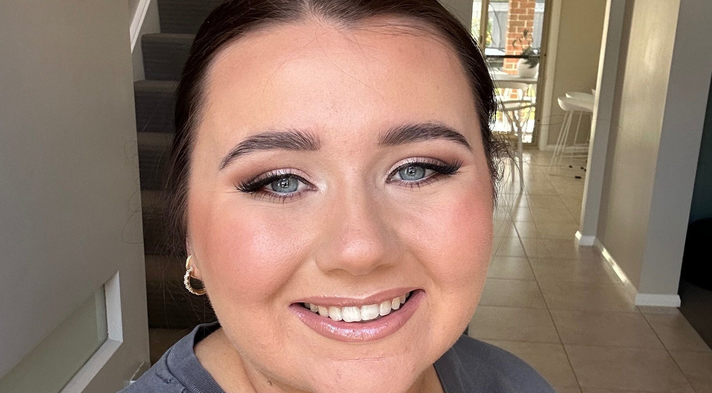 Smiling woman with flawless makeup at Lux Aesthetics By Sophie, Narellan, New South Wales, AU.