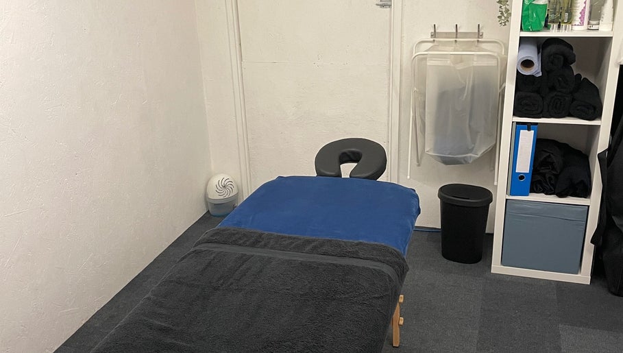 Peaceful massage room at Attiva Massage Therapy, Cardiff, Wales, GB with treatment table and soft lighting.