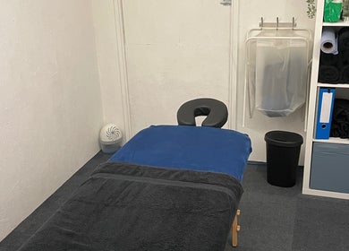 Peaceful massage room at Attiva Massage Therapy, Cardiff, Wales, GB with treatment table and soft lighting.