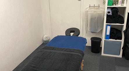 Peaceful massage room at Attiva Massage Therapy, Cardiff, Wales, GB with treatment table and soft lighting.
